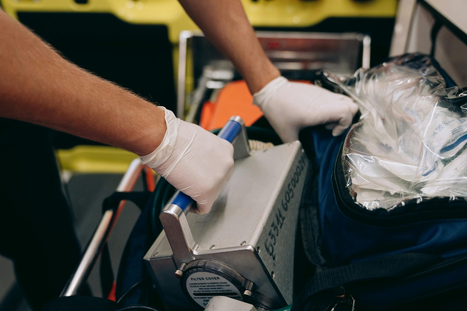 Emergency medical technician organizing equipment in ambulance.
